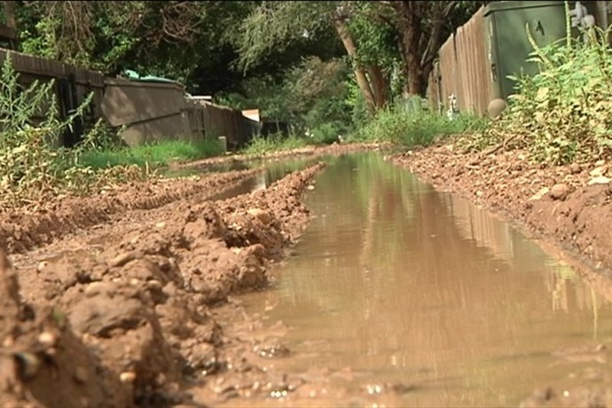 mud muddy alley dumpster trash lubbock_-1984028974468937139