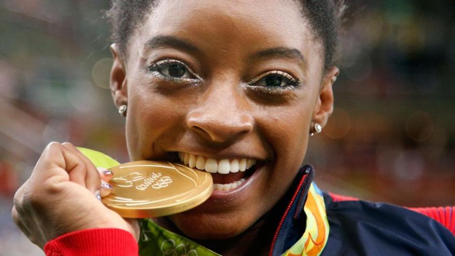 simone-biles_biting-medal_rio-olympics_ap_20160812015512-159532