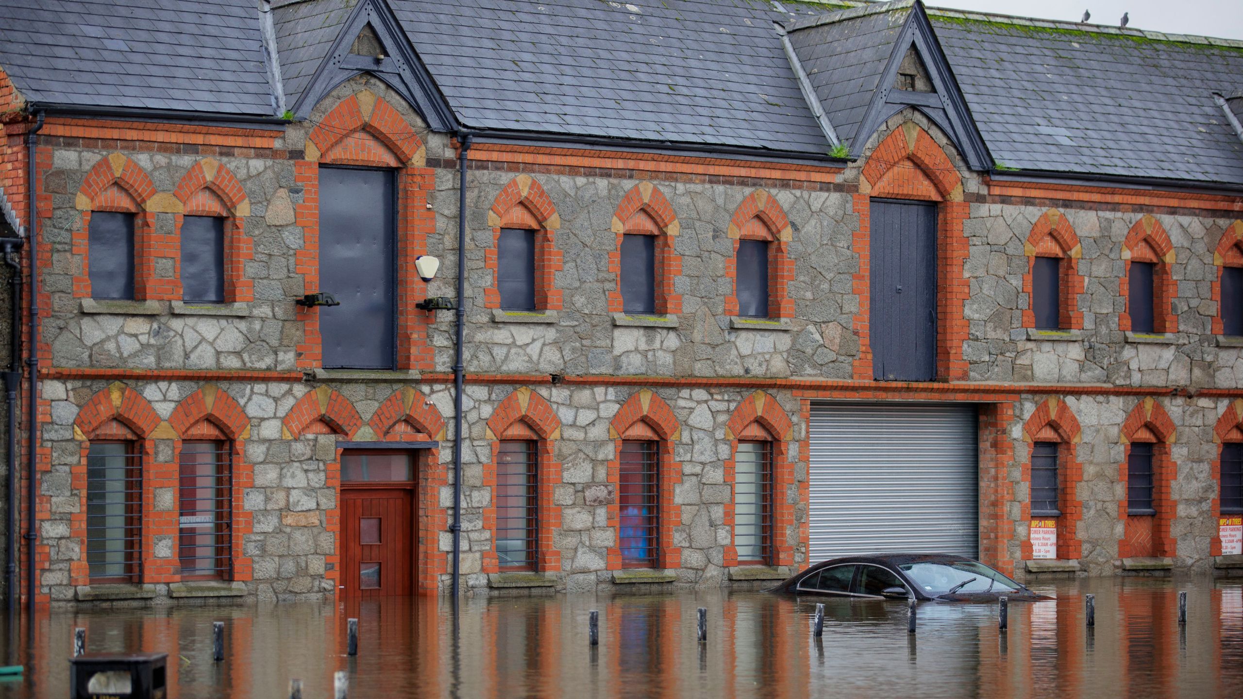 A car submerged in flood water at Basin Walk Car Park in Newry Town, Co Down, Tuesday Oct. 31, 2023. Flooding was reported in parts of Northern Ireland, with police cautioning people against travelling due to an amber rain warning. (Liam McBurney/PA via AP)