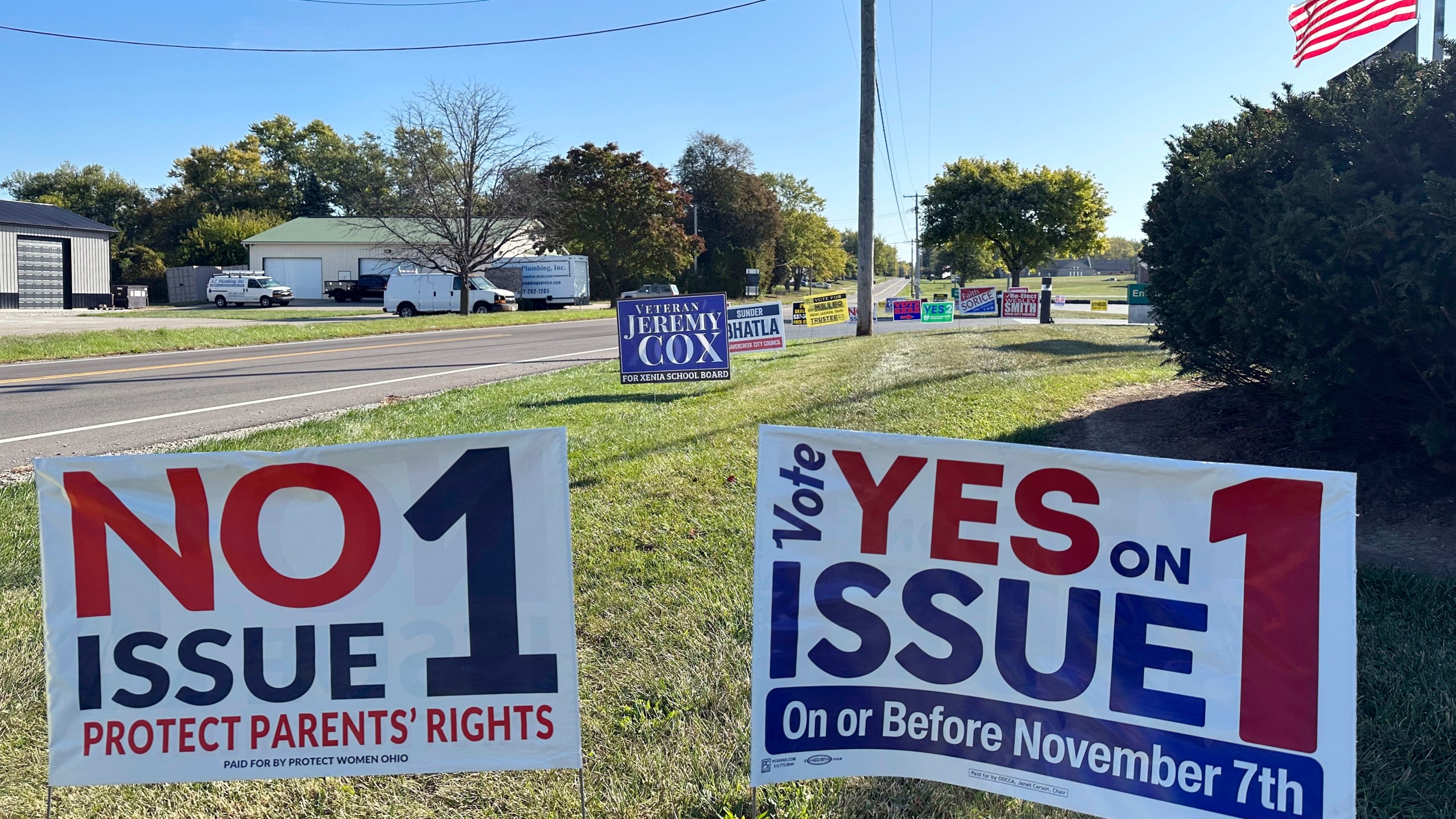 Signs for and against a proposed constitutional amendment to protect abortion rights in Ohio stand in front of the Greene County Board of Elections in Xenia, Ohio, Wednesday, Oct. 11, 2023, the first day of in-person voting. (AP Photo/Julie Carr Smyth)