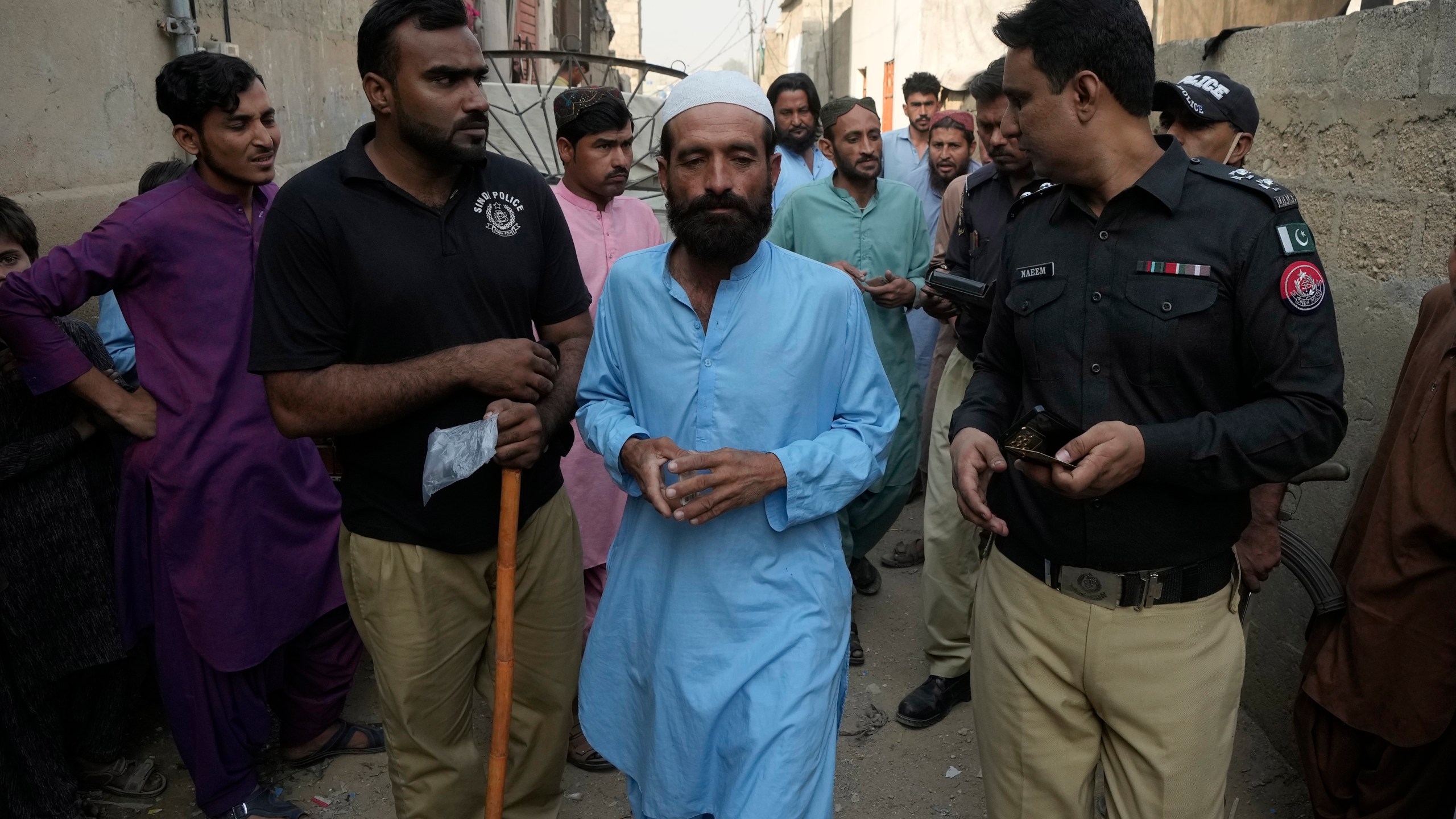 Police officers detain immigrants who fail to provide legal documents during a search operation against illegal immigrants, at a neighborhood of Karachi, Pakistan, Thursday, Nov. 2, 2023. Pakistani security forces have rounded up, detained and deported dozens of Afghans who were living in the country illegally, after a government-set deadline for them to leave expired, authorities said. (AP Photo/Fareed Khan)