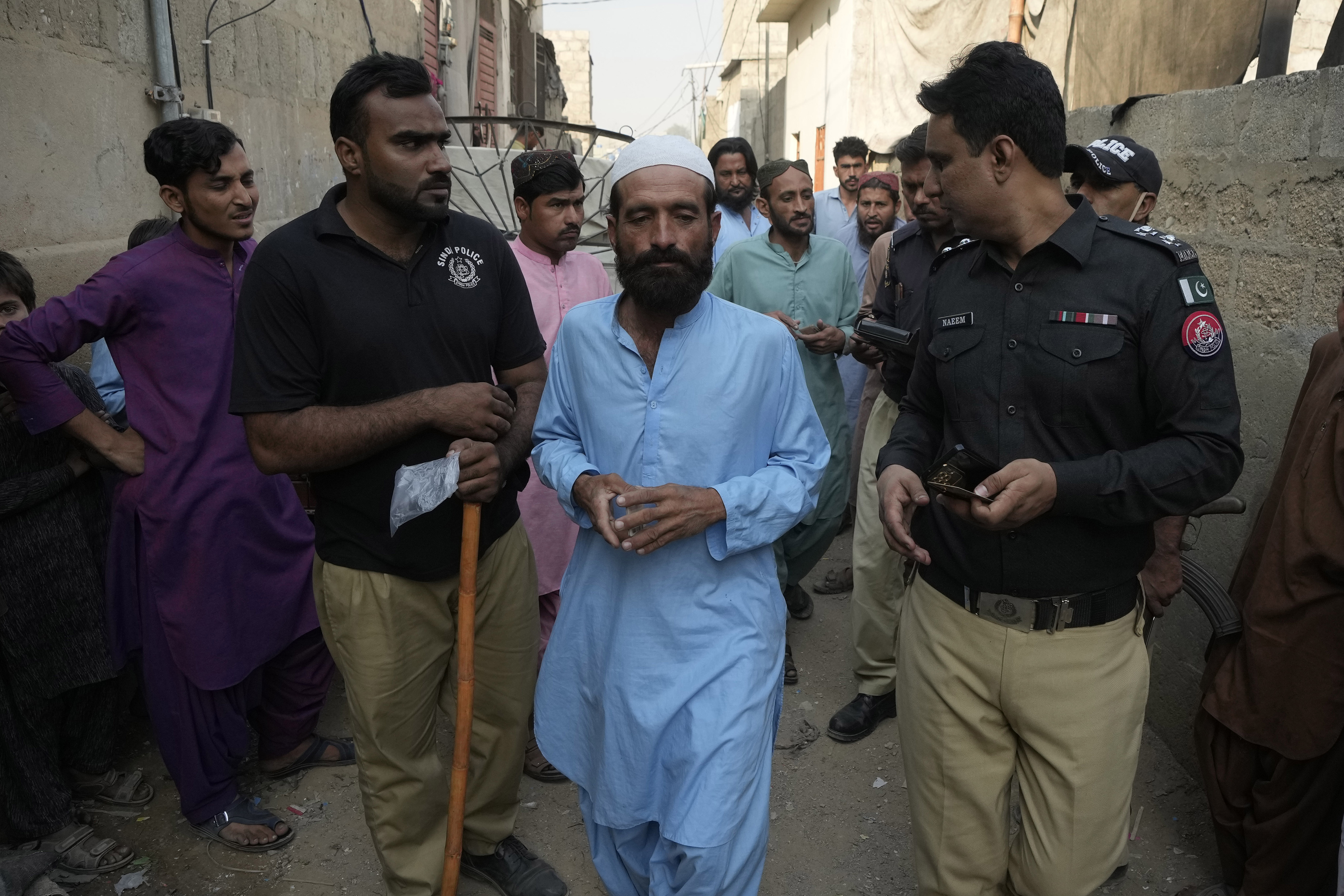 Police officers detain immigrants who fail to provide legal documents during a search operation against illegal immigrants, at a neighborhood of Karachi, Pakistan, Thursday, Nov. 2, 2023. Pakistani security forces have rounded up, detained and deported dozens of Afghans who were living in the country illegally, after a government-set deadline for them to leave expired, authorities said. (AP Photo/Fareed Khan)