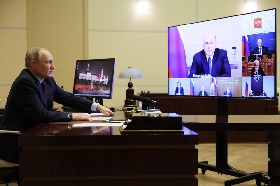 Russian President Vladimir Putin chairs a meeting on economic issues via videoconference at the Novo-Ogaryovo state residence outside Moscow, Russia, Wednesday, Nov. 1, 2023. Russian Prime Minister Mikhail Mishustin is seen on the screen. (Gavriil Grigorov, Sputnik, Kremlin Pool Photo via AP)