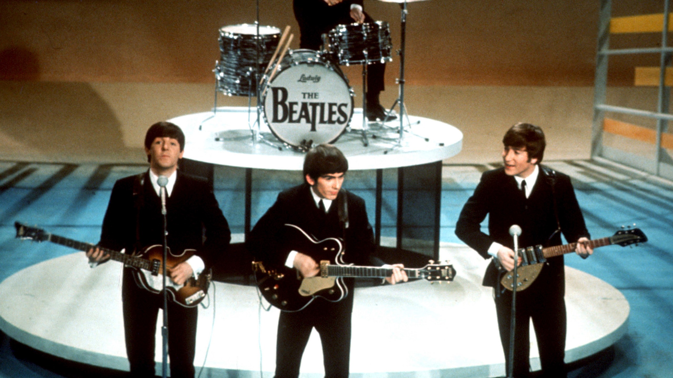 FILE -The Beatles, foreground from left, Paul McCartney, George Harrison, John Lennon and Ringo Starr on drums perform on the CBS "Ed Sullivan Show" in New York on Feb. 9, 1964. Sixty years after the onset of Beatlemania and with two of the quartet now dead, artificial intelligence has enabled the release of a “new” Beatles song.“Now And Then,” will be available Thursday, Nov. 2. (AP Photo/File)