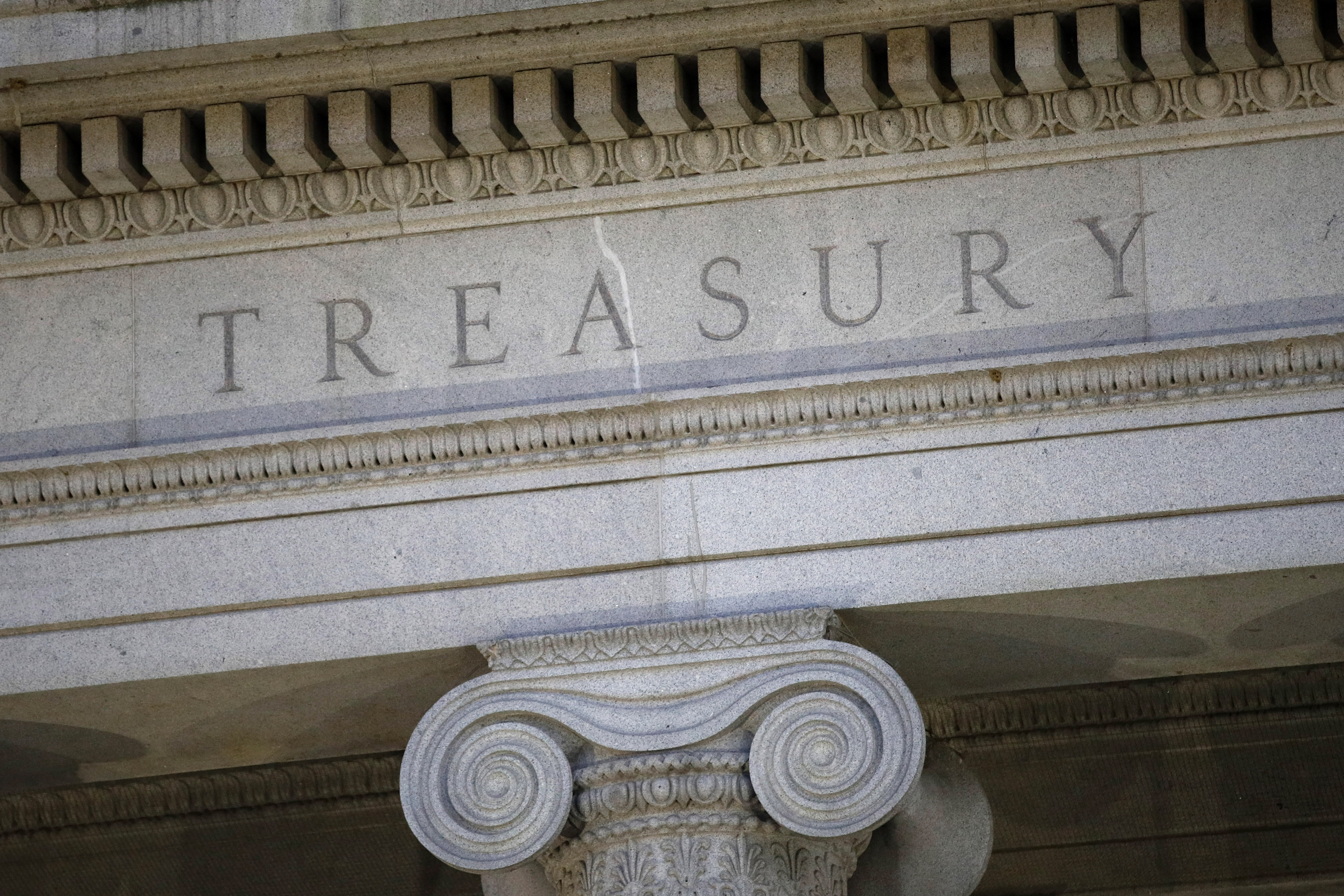 FILE- The U.S. Treasury Department building is shown at dusk in Washington on June 6, 2019. The United States on Thursday imposed a new round of sanctions on roughly 130 firms and people from Turkey to China to the United Arab Emirates in an effort to choke off Moscow’s access to tools and equipment that support its invasion of Ukraine. (AP Photo/Patrick Semansky, File)